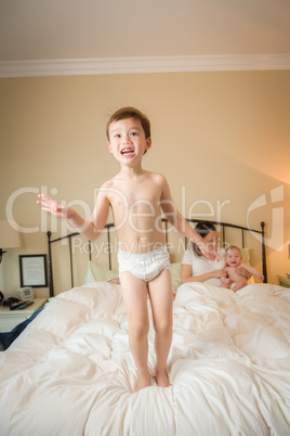 Mixed Race Chinese and Caucasian Boy Jumping In Bed with His Fam