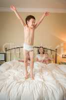 Mixed Race Chinese and Caucasian Boy Jumping In Bed with His Fam