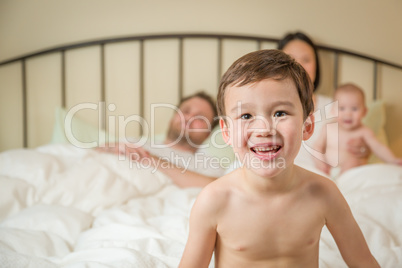 Mixed Race Chinese and Caucasian Boy Laying In Bed with His Fami