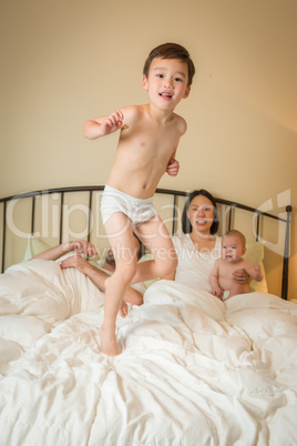 Mixed Race Chinese and Caucasian Boy Jumping In Bed with His Fam