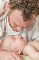 Mixed Race Chinese and Caucasian Baby Boy In Bed with His Father