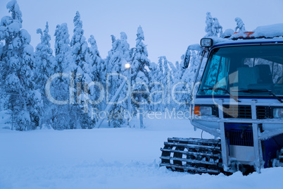 Winter Evening and the Snowcat on the Edge of the Forest
