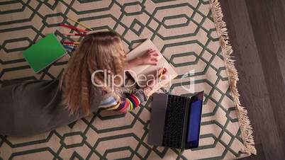 Schoolgirl doing her homework at home.