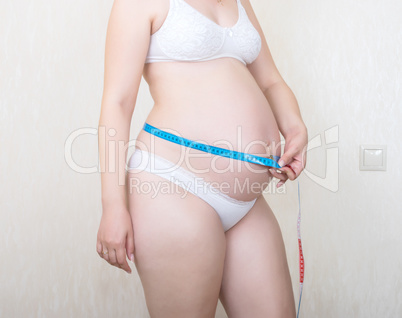 Expectant mother with tape-measure