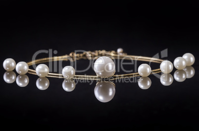 White pearls necklace on black background