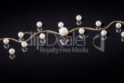 White pearls necklace on black background