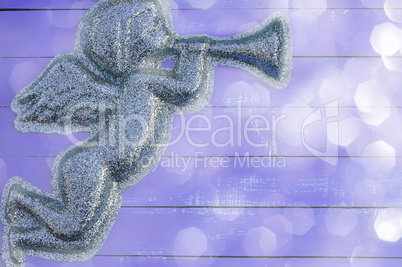 Figure angel of shiny particles on a  purple background