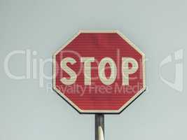Vintage looking Stop sign over blue sky