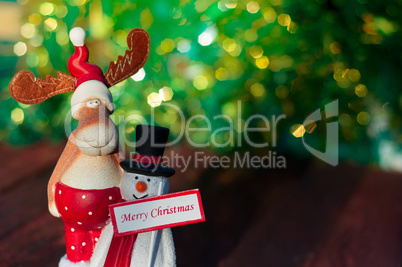 Christmas Elk with a snowman standing on a blurred background Ch