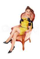 Beautiful woman in armchair with a cigarette.