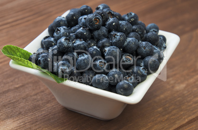 Blueberry heap with leaves in the bowl