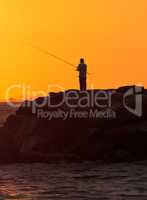 Silhouette of Men fish on the pier off Balboa Island