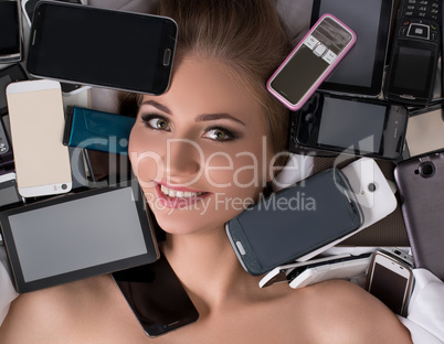 Digital technology as fetish. Girl with mobiles