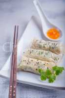 Spring Rolls with Sauce on a wooden surface