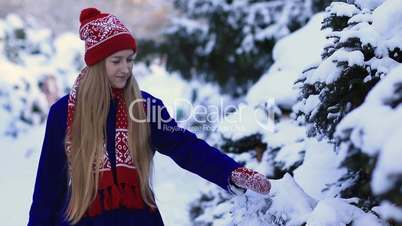 Young woman walking in snow forest