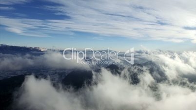 Aerial Drone Flying over Mountains and Clouds