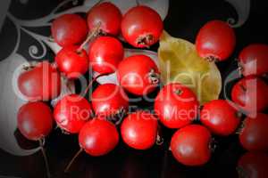 Hawthorn berries on a plate .