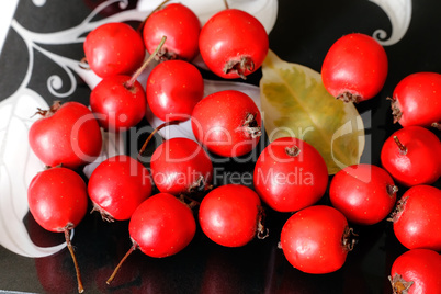 Hawthorn berries on a plate .
