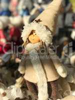 Christmas doll in winter clothes with a scarf