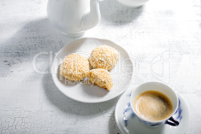 Almond cookies and coffee on white table
