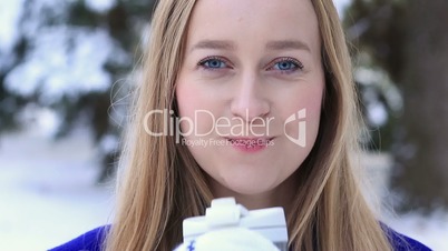 Woman drinking hot wine from thermocup in winter