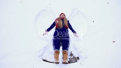 Young happy woman having fun on snow