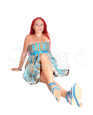 Red hair woman sitting on floor.