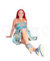 Red hair woman sitting on floor.