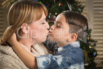 Mother and Mixed Race Son Hug Near Christmas Tree