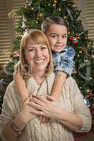 Mother and Mixed Race Son Hug Near Christmas Tree