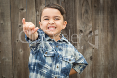 Young Mixed Race Boy Making Shaka Hand Gesture