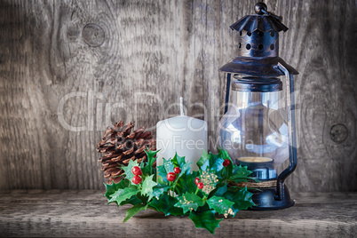 Christmas ornaments and candle light on rustic wood