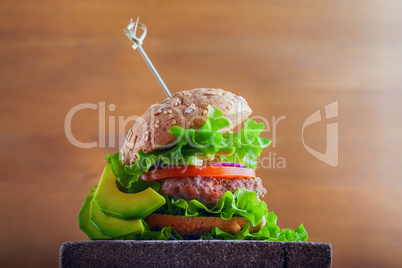 Delicious homemade burger on rustic wooden desk