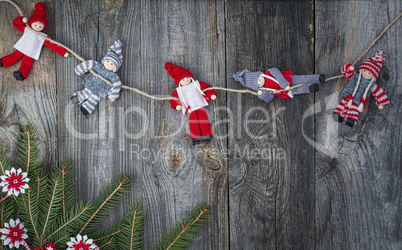 Rag Doll Christmas hanging on the rope on gray old wooden surfac