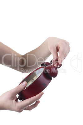 Female hand with alarm clock