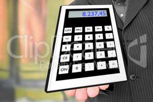 Man holds pocket calculator