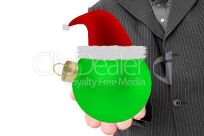 Man holds decorated Christmas ball