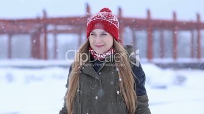 Happy young woman enjoying first snow
