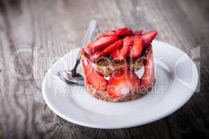 Strawberry and custard tart on a white plate