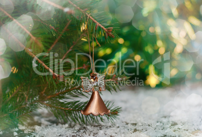 Celebratory background with Christmas toy hanging on fir branch