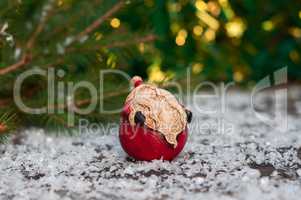 Ceramic Santa Claus on a small snow-covered wood surface