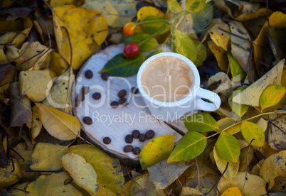 White cup with espresso coffee on a wooden stump