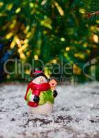 Small ceramic snowman among the snow