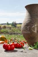 Tomatoes and old clay jug