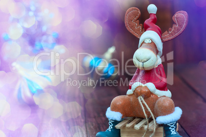 Christmas background with a toy moose on wooden sled