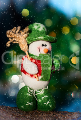 Textile snowman on a log