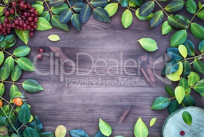 Brown wood background with fallen leaves