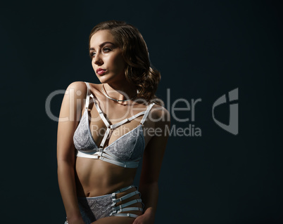 Woman in lingerie posing on  black background