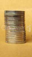 Euro and Pound coins pile - vertical