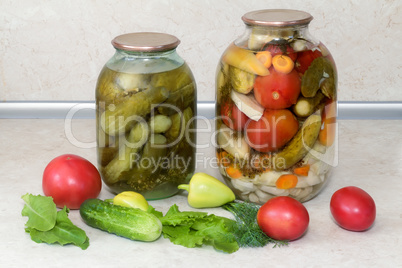 A variety of canned vegetables in glass jars.
